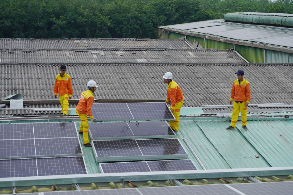 Professional solar installation workers on a roof