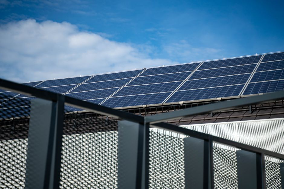 Sun shining brightly over a home with a solar roof